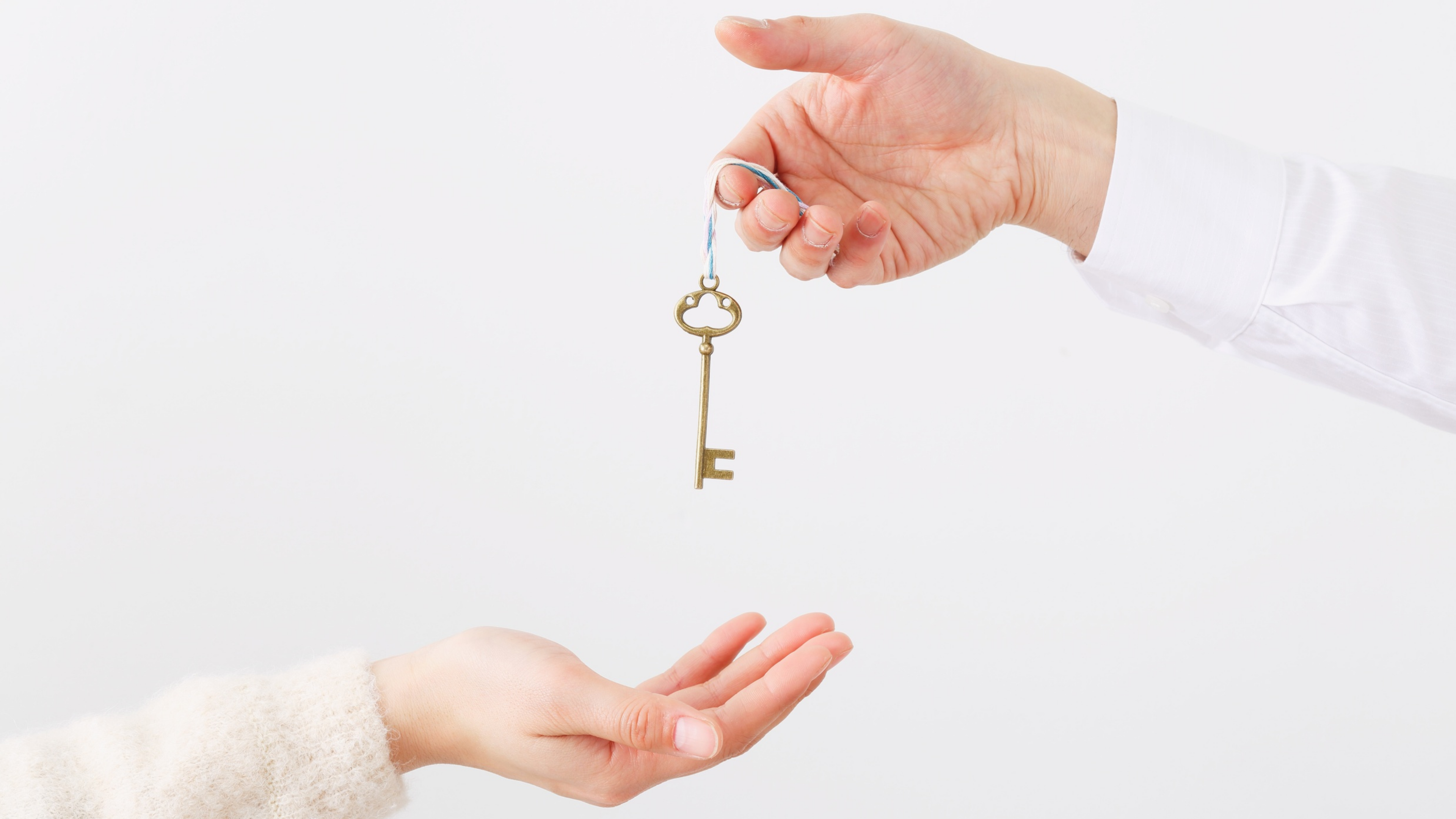 Someone handing the keys to a home over to another person.