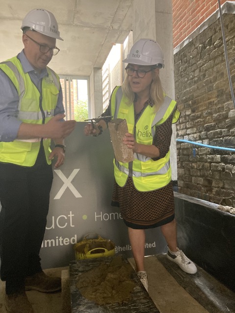 Ruth Davison lays the first brick at the development.