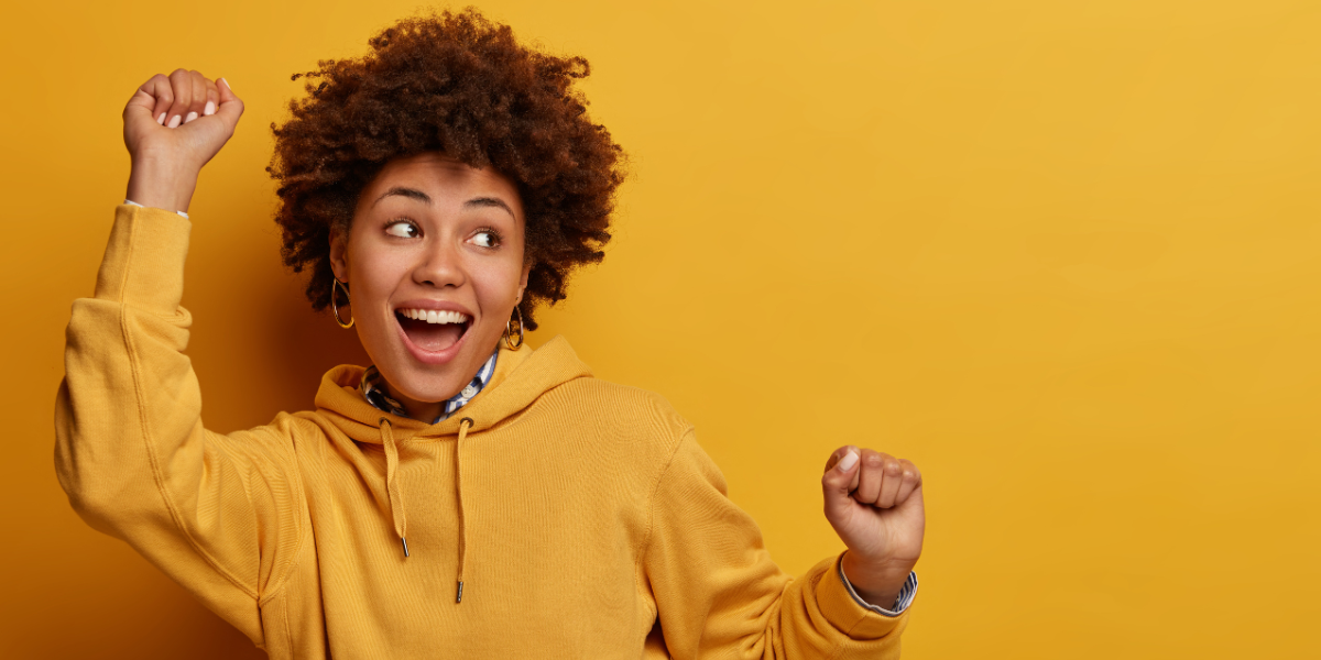 Smiling woman celebrates winning a prize. 