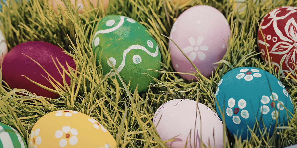 Painted eggs in a field.